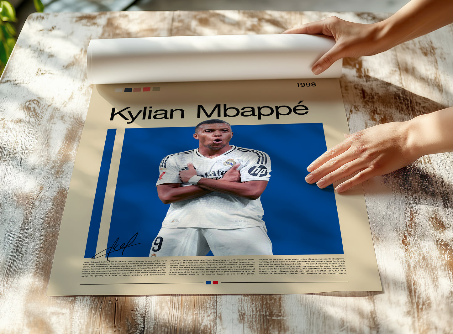 Minimalist poster of Kylian Mbappé in a Real Madrid jersey celebrating his signature pose on a deep blue background. Elegant beige layout with modern typography and French flag accent. A premium football wall art print for fans, collectors, and lovers of modern sports aesthetics.