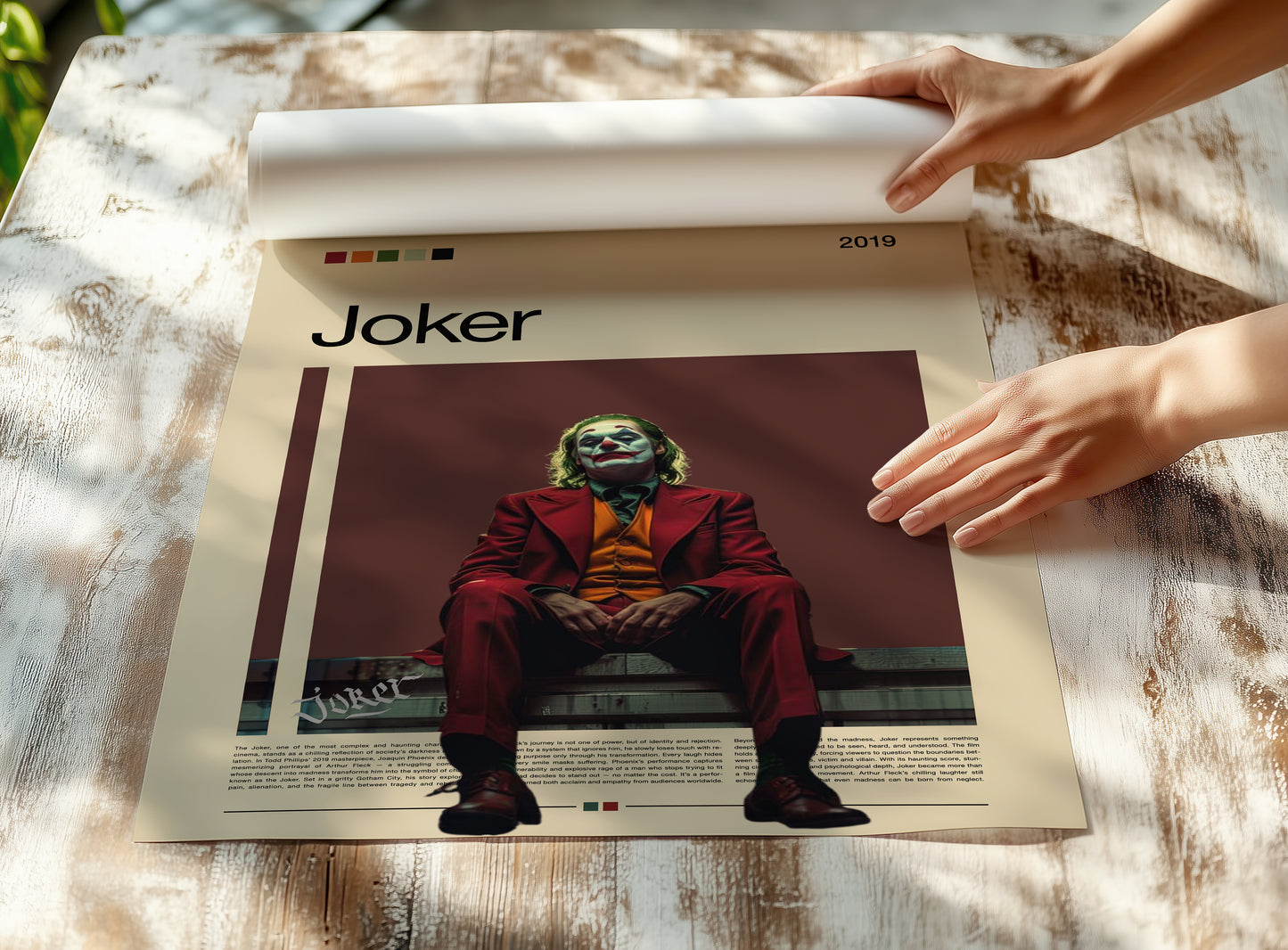 Minimalist Joker poster featuring Joaquin Phoenix in a red suit sitting under moody lighting on a dark red background. Inspired by the 2019 film Joker, this cinematic artwork captures emotion, isolation, and power – ideal for film enthusiasts and modern wall decor lovers.