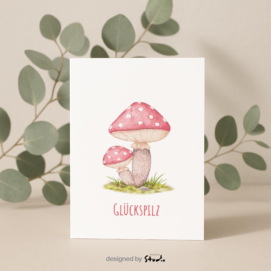 Aquarell-Illustration von zwei roten Fliegenpilzen mit weißen Punkten auf einer grünen Wiese. Darunter steht der Schriftzug „Glückspilz“. Die Karte vermittelt Glück, Wärme und Naturverbundenheit und eignet sich perfekt als Geburtstagskarte, Glückwunschkarte oder kleine Aufmerksamkeit für liebe Menschen.