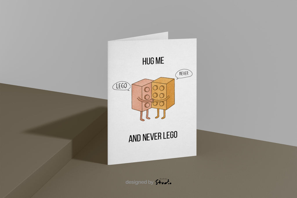 Witzige A6-Grußkarte mit zwei umarmenden Bausteinen im Cartoon-Stil. Der Text „Hug me and never LEGO“ spielt humorvoll auf ein Wortspiel an. Die Figuren wirken süß und freundlich, mit Sprechblasen „Lego“ und „Never“. Minimalistisches, helles Design, ideal als liebevolle und humorvolle Karte für Partner oder Freunde.