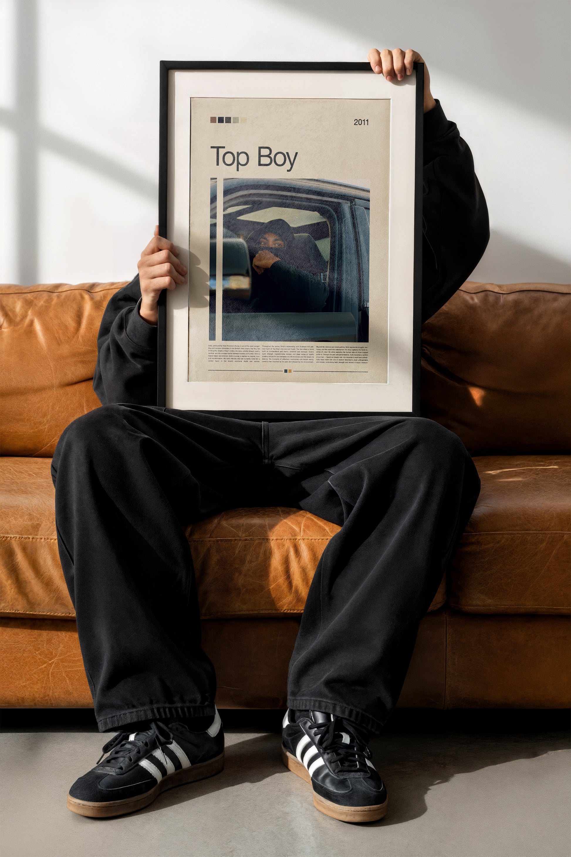 Cinematic Top Boy poster featuring Sully in a car, wearing a black hood under moody urban lighting. Minimal design with beige background and warm color tones. Perfect for fans of British dramas and modern street aesthetic wall art. Great for collectors and urban interior style.