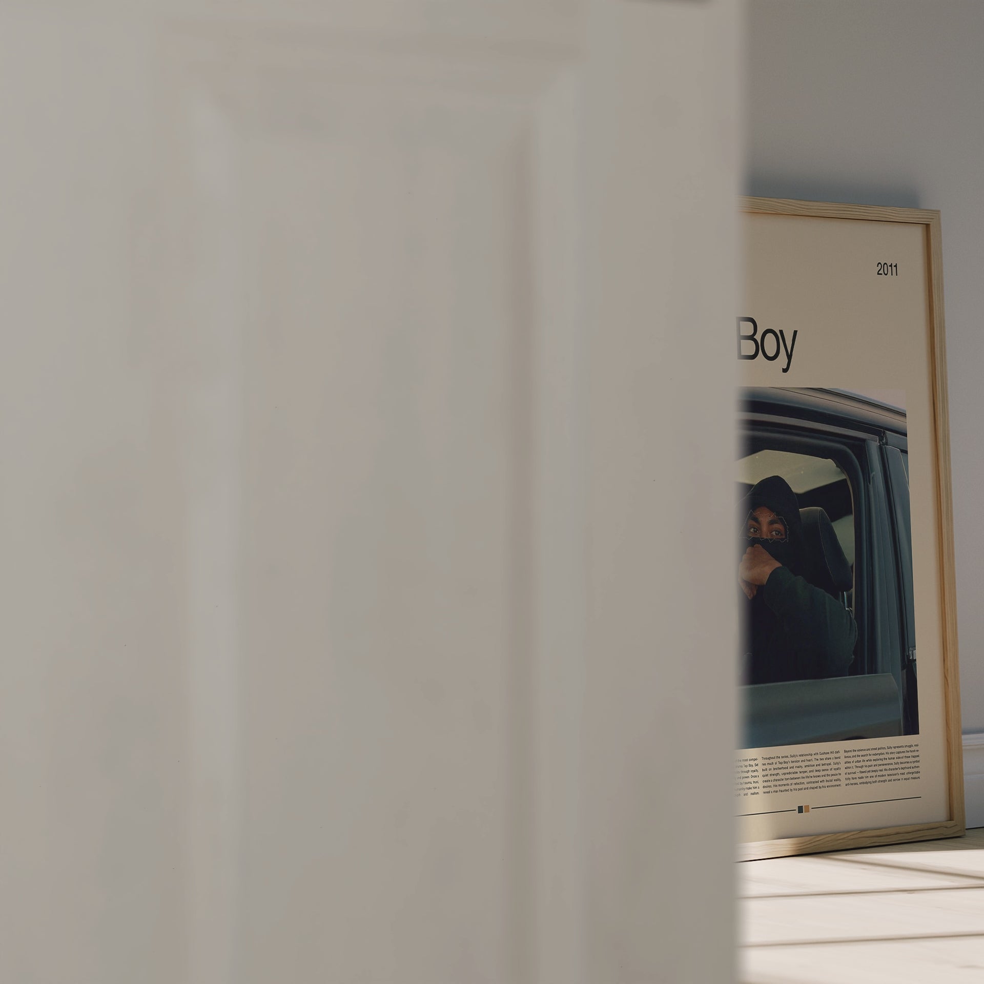 Cinematic Top Boy poster featuring Sully in a car, wearing a black hood under moody urban lighting. Minimal design with beige background and warm color tones. Perfect for fans of British dramas and modern street aesthetic wall art. Great for collectors and urban interior style.