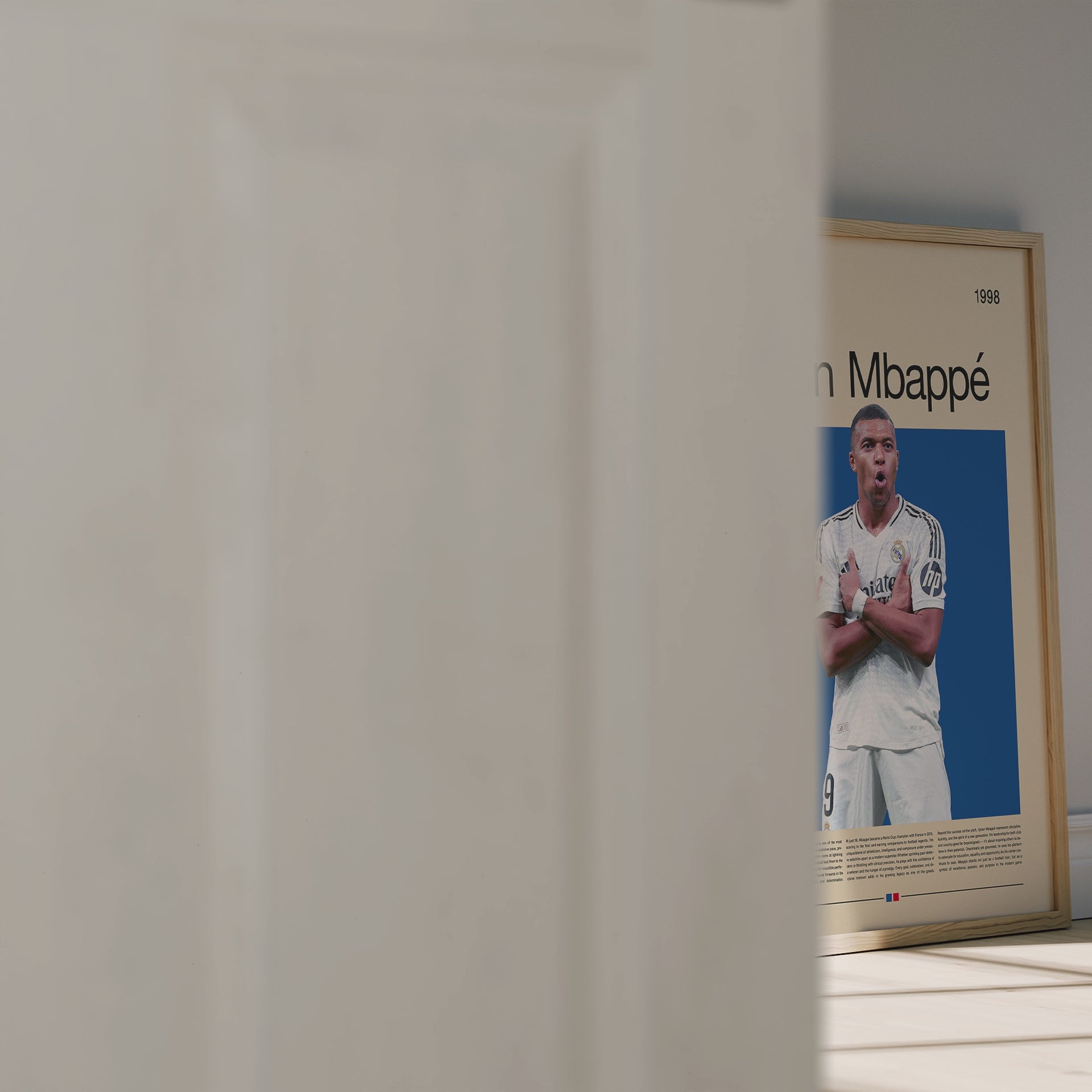 Minimalist poster of Kylian Mbappé in a Real Madrid jersey celebrating his signature pose on a deep blue background. Elegant beige layout with modern typography and French flag accent. A premium football wall art print for fans, collectors, and lovers of modern sports aesthetics.